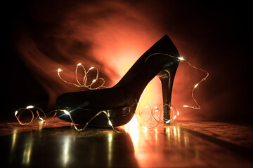 Silhouette of a high heel women shoes at dark. Women power or women domination concept.