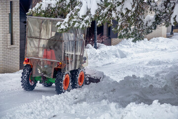 Mini tractor clears snow