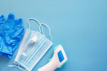 Corona virus protection concept flat lay. Non-contact infrared body thermometer, latex gloves,...