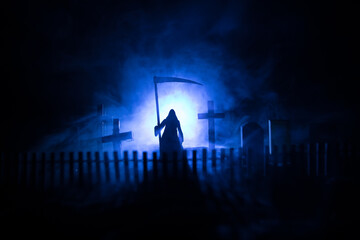 Scary view of zombies at cemetery dead tree, moon, church and spooky cloudy sky with fog, Horror Halloween concept with glowing pumpkin. Selective focus