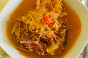 Hungarian cabbage soup with pork in white plate