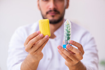 Young male chemist testing soap in the lab