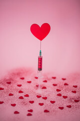 Creative love concept on pink background. The vaccine of love with hearts.Minimal flat lay.
