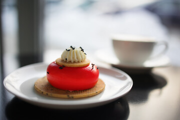 red strawberry cheesecake stuffed with cappuccino on a black table