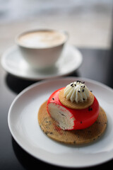 red strawberry cheesecake stuffed with cappuccino on a black table