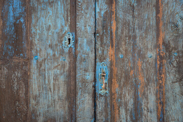 antique dirty blue wooden door with an handle and a lock