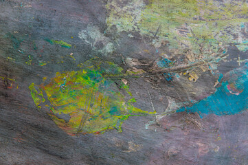 colorful creative motley background: smudged residues of oil paints on a wooden palette, short...