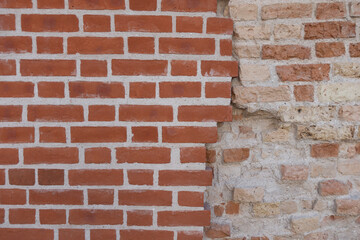 Old vintage weathered grunge brick wall and modern red brick wall with crack between. Abstract wall texture background