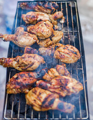 Preparing Delicious Smoky Grilled Barbecue on the charcoal flame outdoors.