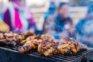 Preparing Delicious Smoky Grilled Barbecue on the charcoal flame outdoors.