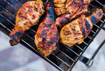 Preparing Delicious Smoky Grilled Barbecue on the charcoal flame outdoors.