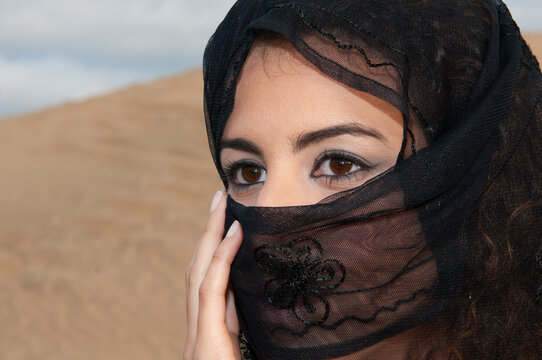 Veiled Muslim Woman In The Desert