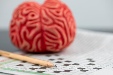 Alzheimer and brain training concept, Brain and crossword Puzzle with pencil