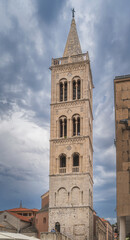 Tall bell tower of a St. Donata Church in early Romanesque architecture in Zadar old town, Croatia. Dramatic, stormy sky