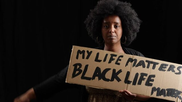 My Life matters said by female black live matters protester holding a cardboard sign