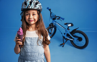Closeup portrait of a cute little girl eating an ice cream