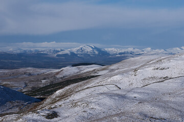 Fototapeta na wymiar snow covered mountainous scenery on a freezing summer day in Scotland