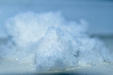 Close-up of fallen snow on a blue background.