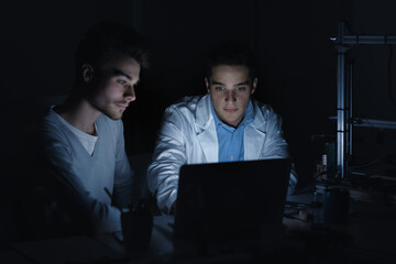 Engineering students in the lab at night