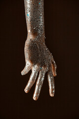 Obraz premium Glittering silver body art on female hand, close up of sparkling woman's arm, skincare concept