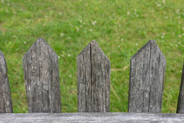Old vintage wooden fence on the meadow. 