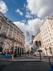 busy crossing in london, united kingdom with tower 42 in the back