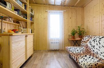 Interior of a small kitchen with a set of wood in a country house