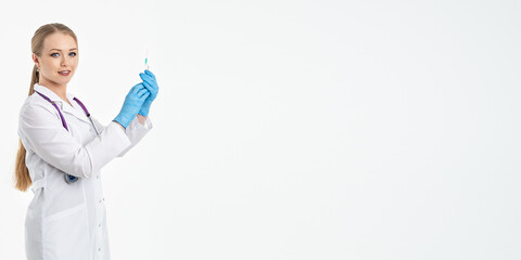 A young nurse in a mask and white coat holds a syringe with a needle for injections, flu shots, covid. The concept of vaccination and protection against influenza, from a pandemic. copy space. banner