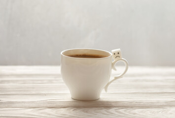 White sugar cube on cup of coffee. Smile. Concept.