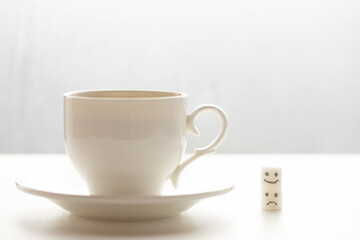 White sugar cube on cup of coffee. Smile. Concept.