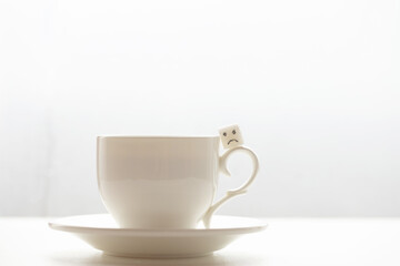 White sugar cube on cup of coffee. Smile. Concept.