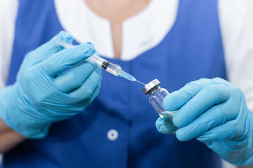 women's hands in medical gloves, vaccination