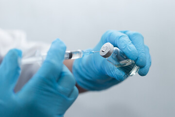 women's hands in medical gloves, vaccination
