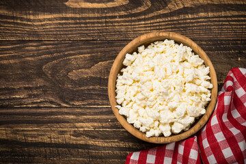 Curd or cottage cheese at wooden table. Farmer tvorog. Top view with copy space.