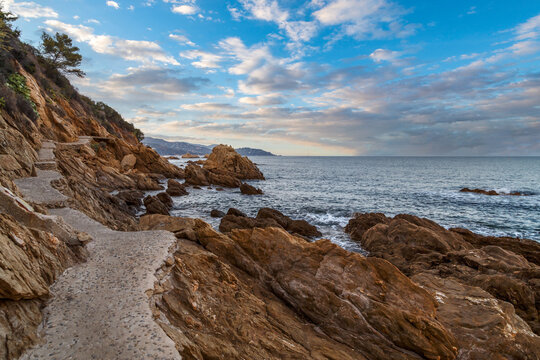 Le Lavandou, France. Ecological stone trail along the rocky coast of Mediterranean sea. Provence, French Riviera.