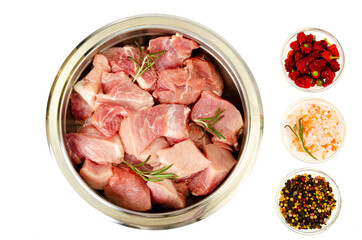 Chunks of fresh raw meat in metal bowl on white background. Studio Photo