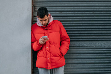 young man with mobile phone in the city