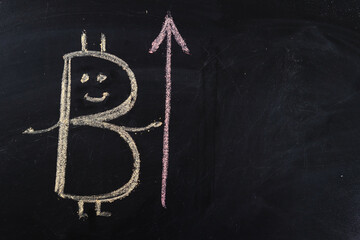 Chalk drawing on the bitcoin board and the arrow of the rate growth chart. Copy space for text