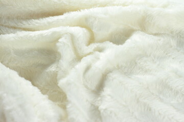 White fluffy fur furry plaid for bed, bedding texture, stripes pattern, wrinkled woven light material 