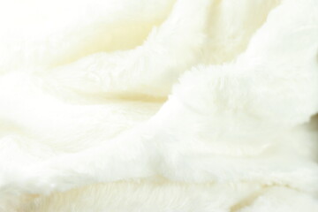 Fototapeta na wymiar White fluffy fur furry plaid for bed, bedding texture, stripes pattern, wrinkled woven light material 
