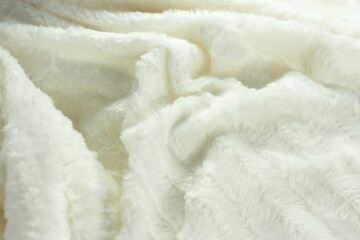 White fluffy fur furry plaid for bed, bedding texture, stripes pattern, wrinkled woven light material 