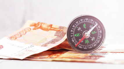 Compass and five thousand rubles bills