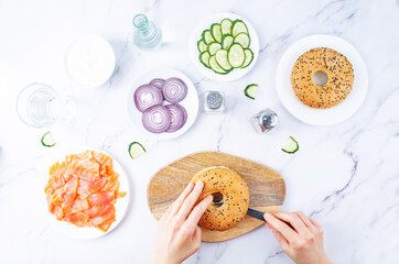 Marble table with ingredients for making bagel or sandwich for lunch
