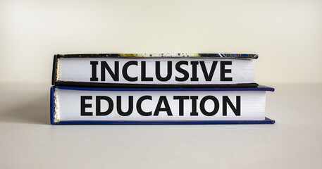 Inclusive education symbol. Books with words 'Inclusive education' on beautiful white background....