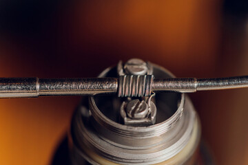 Specialist replaces spring for smoking vape.Professional maintaining electronic cigarette in...