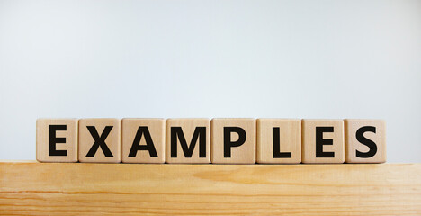 Examples symbol. Concept word 'examples' on wooden cubes on a beautiful wooden table. White background. Business and examples concept.