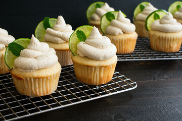 Moscow Mule Cupcakes on Wire Cooling Racks: Freshly baked cupcakes topped with ginger beer and lime frosting