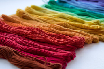 Multicolored floss threads for embroidery. Rainbow gradient. Close-up.
