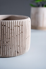 Creative Composition with concrete pink flower pot. on a blue background. Minimalism. Natural material. DIY. Eco-friendly.