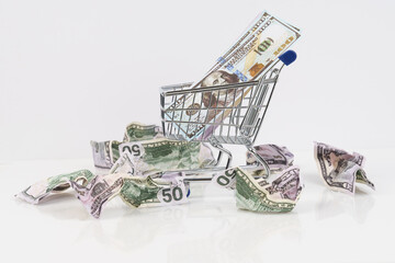 Crumpled money and money cart on the table